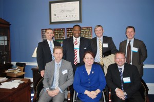 Standing, third from left, Chris Steinway and other railroad representatives join Illinois Congresswoman Tammy Duckworth.