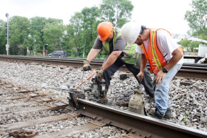 From left, Nick Blakemore, welder helper, and Michael Martinez, track foreman, replace rail.